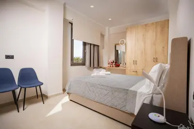 a bedroom with a bed and a table and chairs at Polixenys home in Daratso
