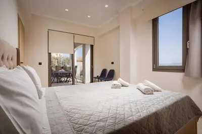a bedroom with a bed with two towels on it at Polixenys home in Daratso