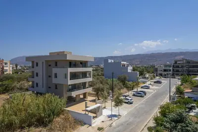 a building on the side of a road next to a street at AURA - Deluxe Apartment in Chania Town