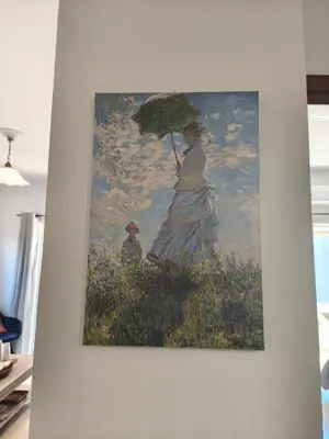 a painting of a woman and child with an umbrella at Van Gogh & Monet apartments in Maleme