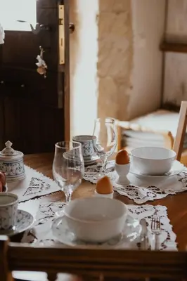 a table with plates and wine glasses on it at Ewa's Cretan Vintage Houses in Kharkhalianá