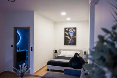 a bedroom with a bed and a painting on the wall at Breezy Sea View Appartment in Chania Town