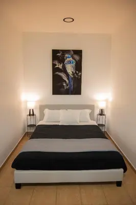 a bedroom with a large bed with two lamps at Breezy Sea View Appartment in Chania Town
