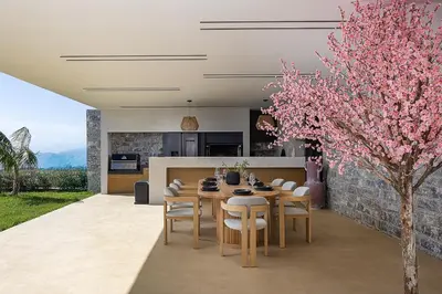 a kitchen and dining room with a table and a tree at Etheria Elli Villa, Retreat to Ethereal Luxury and Wellness by etouri in CHQ