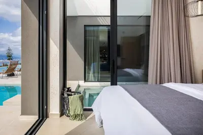 a bedroom with a bed and a swimming pool at Etheria Elli Villa, Retreat to Ethereal Luxury and Wellness by etouri in CHQ