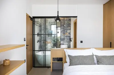 a bedroom with a bed and a bathroom with a tub at Etheria Elli Villa, Retreat to Ethereal Luxury and Wellness by etouri in CHQ