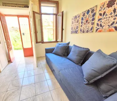 a blue couch sitting in a living room at Casa Kadanoleon old town with private terrace in Chania Town