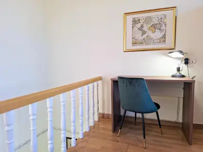 a desk with a blue chair next to a staircase at Casa Kadanoleon old town with private terrace in Chania Town