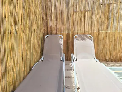 two empty beds in a room with a wall at Casa Kadanoleon old town with private terrace in Chania Town