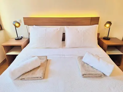 a bedroom with a large white bed with two pillows at Casa Kadanoleon old town with private terrace in Chania Town