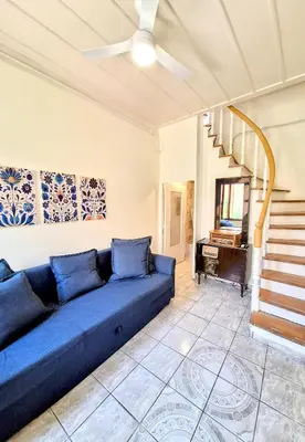 a blue couch in a living room with a piano at Casa Kadanoleon old town with private terrace in Chania Town