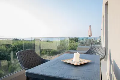 a blue table with a candle and chairs on a balcony at Welcome U2 in Gerani Chanion