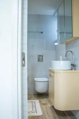 a bathroom with a white toilet and a sink at Welcome U2 in Gerani Chanion