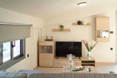 a living room with a large flat screen tv at Welcome U2 in Gerani Chanion