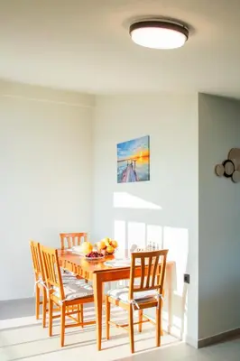 a dining room with a wooden table and chairs at Welcome U2 in Gerani Chanion