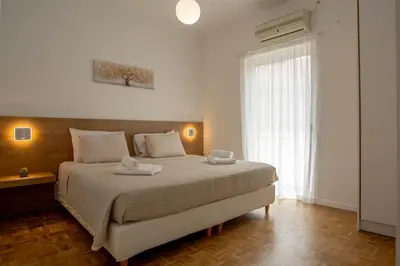a bedroom with a large bed with towels on it at Be Crete - Miramare apartment in Chania Town