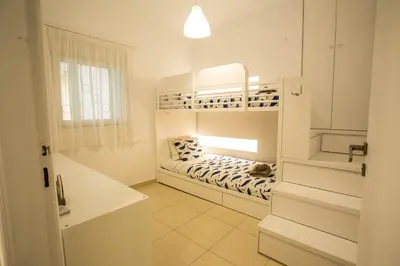 a small white room with a bunk bed in it at Be Crete - Miramare apartment in Chania Town