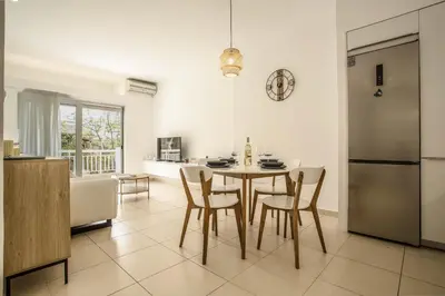a kitchen and dining room with a table and chairs at Be Crete - Miramare apartment in Chania Town
