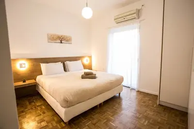 a bedroom with a large bed in a room at Be Crete - Miramare apartment in Chania Town