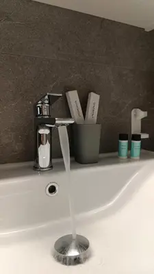a bathroom sink with a faucet on a counter at Stelina Apartment in Chania Town