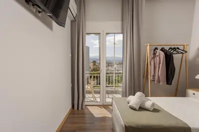 a bedroom with a bed and a window with a view at Zen City Apartment in Chania Town