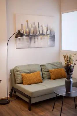 a living room with a couch and a table at Zen City Apartment in Chania Town