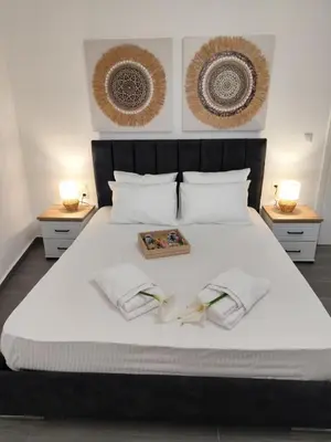 a bed with two towels and a box on it at Stone Villa Aori in Pemónia