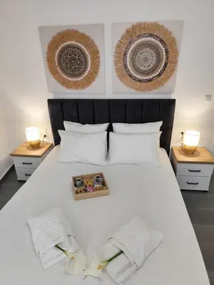 a bedroom with a white bed with a box on it at Stone Villa Aori in Pemónia