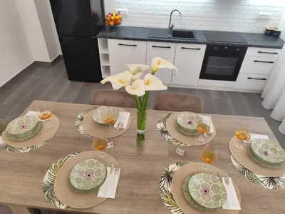 a table with plates and flowers on it in a kitchen at Stone Villa Aori in Pemónia