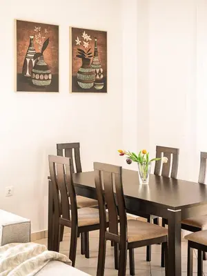 a dining room with a black table and chairs at Chania sea view apartment - Crete in Galatás