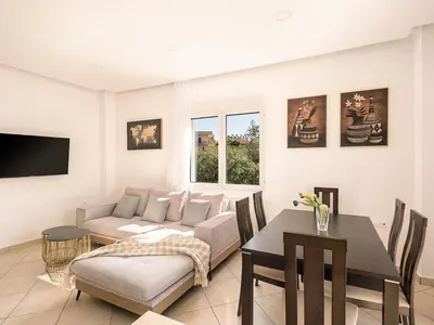a living room with a couch and a table at Chania sea view apartment - Crete in Galatás