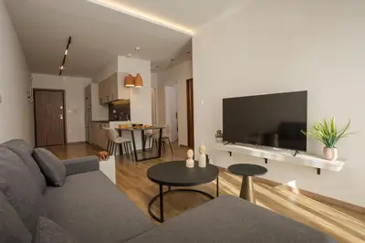 a living room with a couch and a tv at Theni City Apartment by Zen Estate in Chania Town