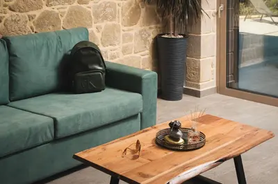 a living room with a couch and a coffee table at Mythelea Luxury Villa in Kissamos