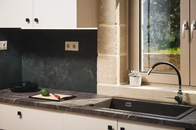 a kitchen with a sink and a counter top at Mythelea Luxury Villa in Kissamos