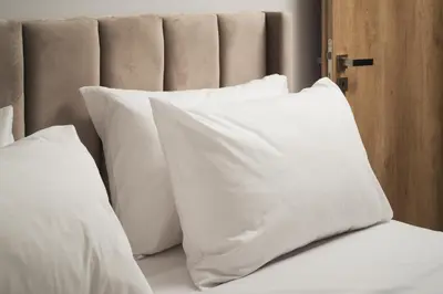 a pile of white pillows on a bed at Mythelea Luxury Villa in Kissamos