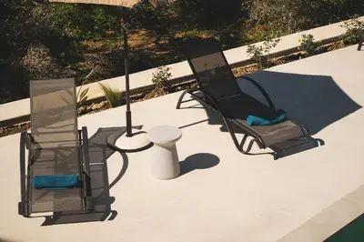 two chairs and a table on a patio at Mythelea Luxury Villa in Kissamos