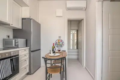 a kitchen with a small table and chairs in it at Dreams 4 you in Chania Town