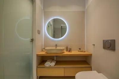 a bathroom with a sink and a mirror at Dreams 4 you in Chania Town