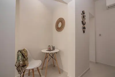 a white room with a table and a chair at Dreams 4 you in Chania Town