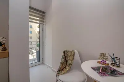 a white room with a white table and a white chair at Dreams 4 you in Chania Town