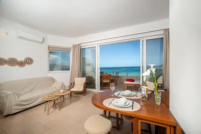 a living room with a table and a view of the ocean at Cielo Vista in Stalos