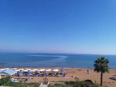a beach with a bunch of umbrellas and the ocean at Cielo Vista in Stalos