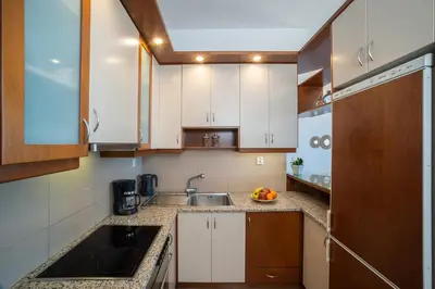 a kitchen with white cabinets and a sink at Cielo Vista in Stalos