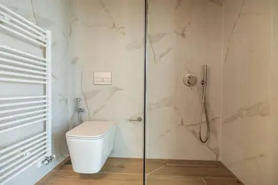 a bathroom with a toilet and a glass shower at Fantasea Villas, villa Lumi in Stérnai