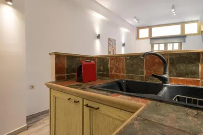 a kitchen with a sink and a red appliance at Crescendo Splantzia in Chania Town
