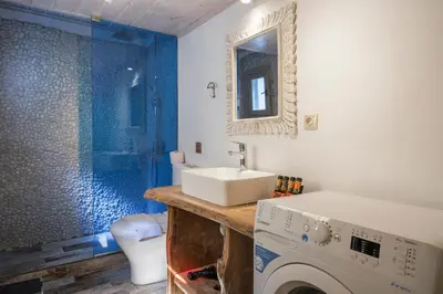 a bathroom with a sink and a washing machine at Crescendo Splantzia in Chania Town