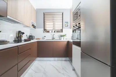 a kitchen with brown cabinets and a sink at Villa Orama - Sea view with private pool in Kalyves