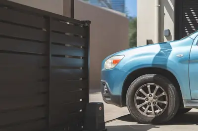 a blue suv parked next to a garage at Villa Orama - Sea view with private pool in Kalyves