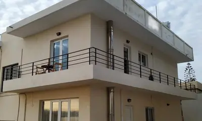 a building with a balcony on top of it at Beachfront apartment in Daratso