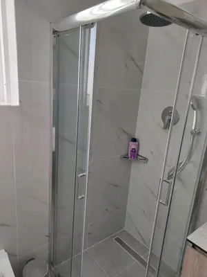 a shower with a glass door in a bathroom at Beachfront apartment in Daratso